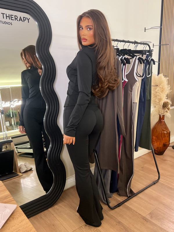 Black Zip Jacket & Wide Leg Trouser Gym Set gym set, side view in modern Pilates studio