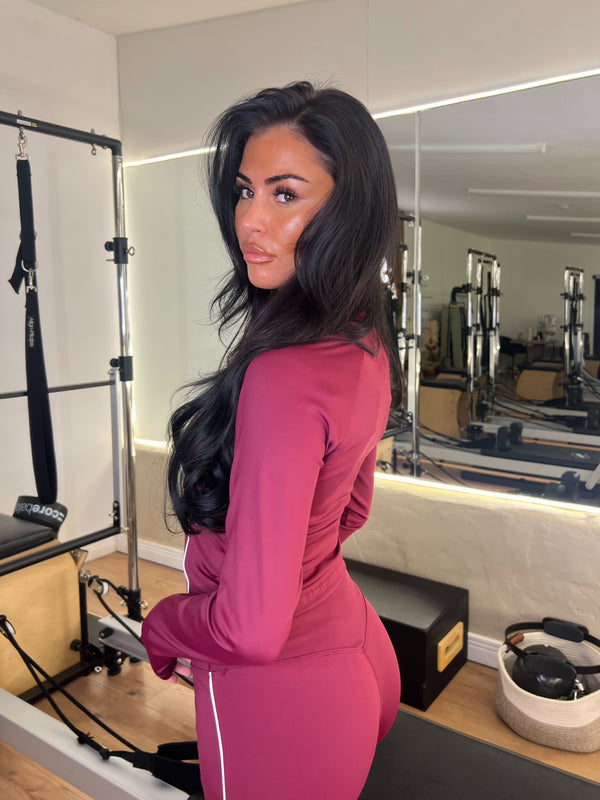 Woman in a pink outfit standing in a gym setting