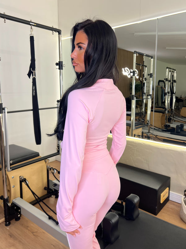 Person wearing a pink outfit in a gym setting