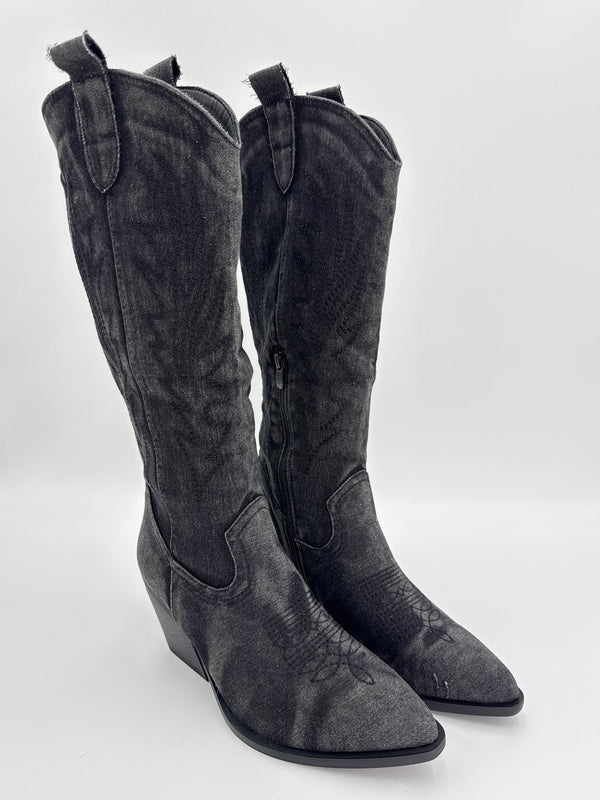 Black knee-high boot with a white background