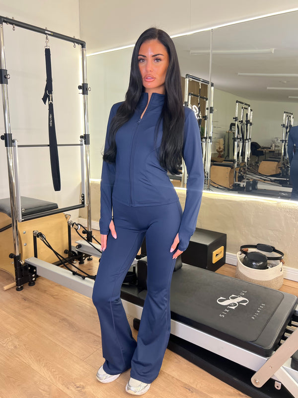 Navy Zip Jacket & Wide Leg Trouser Gym Set women's athleisure set, front view in Pilates studio