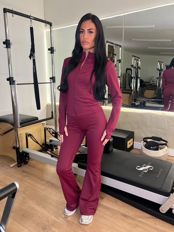 Burgundy Zip Jacket & Wide Leg Trouser Gym Set women's athleisure set, front view in Pilates studio