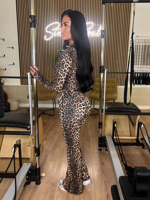 Leopard Zip Jacket Wide Leg Trouser Gym Set gym set, side view in modern Pilates studio
