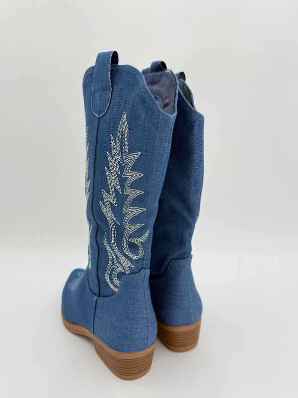 Blue cowboy boots with white embroidery on a light gray background