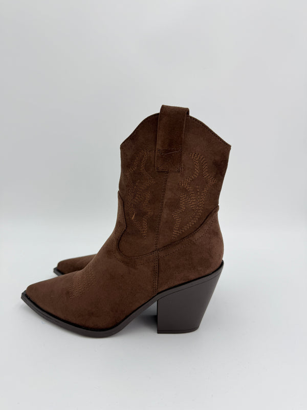 Brown suede ankle cowboy boot with a block heel on a white background
