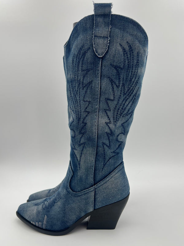Blue denim cowboy boot on a white background