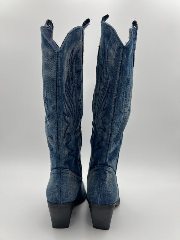 Blue denim cowboy boots on a white background