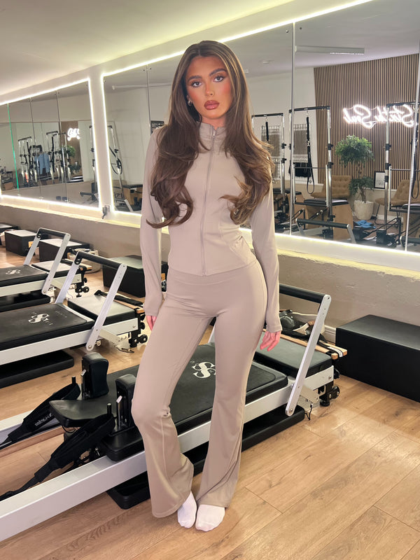Taupe Zip Jacket Wide Leg Trouser Gym Set women's athleisure set, front view in Pilates studio