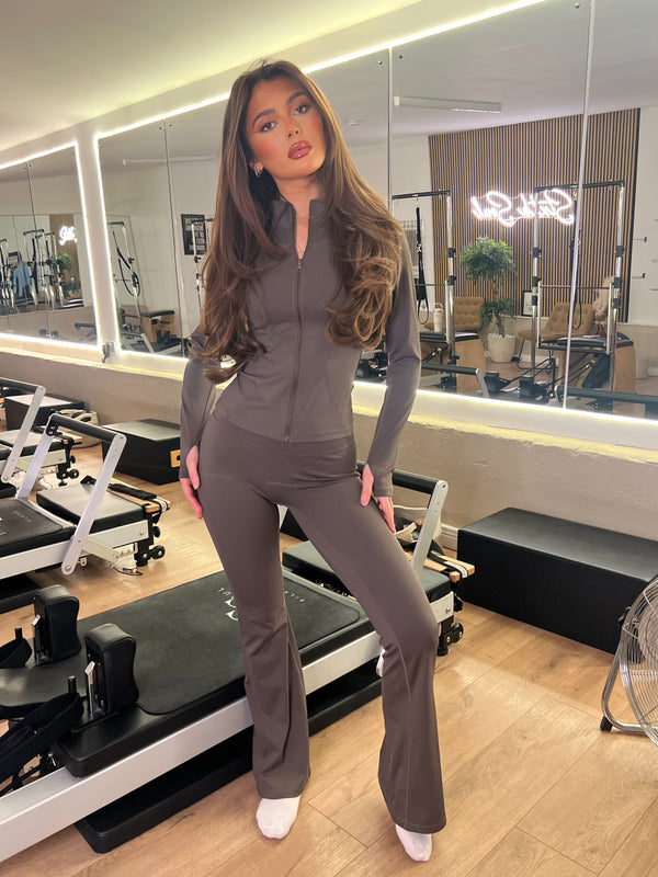 Chocolate Zip Jacket Wide Leg Trouser Gym Set women's athleisure set, front view in Pilates studio