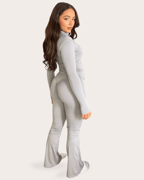 Light Grey Zip Jacket Wide Leg Trouser Gym Set gym set, side view in modern Pilates studio